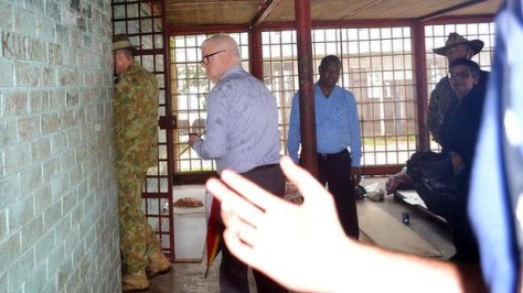 Immigration Department official tries to block Fairfax photographing Lt General Angus Campbell as he visits the squalid Manus Island Police station prison 