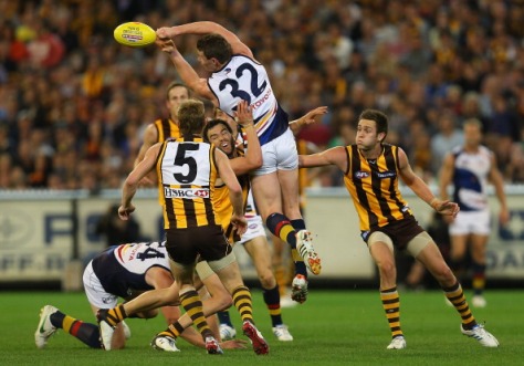 MELBOURNE, AUSTRALIA - SEPTEMBER 22:  Patrick Dangerfield of the Crows handballs whilst being tackled by Jordan Lewis of the Hawks during the second AFL Preliminary Final match between the Hawthorn Hawks and the Adelaide Crows at the Melbourne Cricket Ground on September 22, 2012 in Melbourne, Australia.  (Photo by Quinn Rooney/Getty Images)